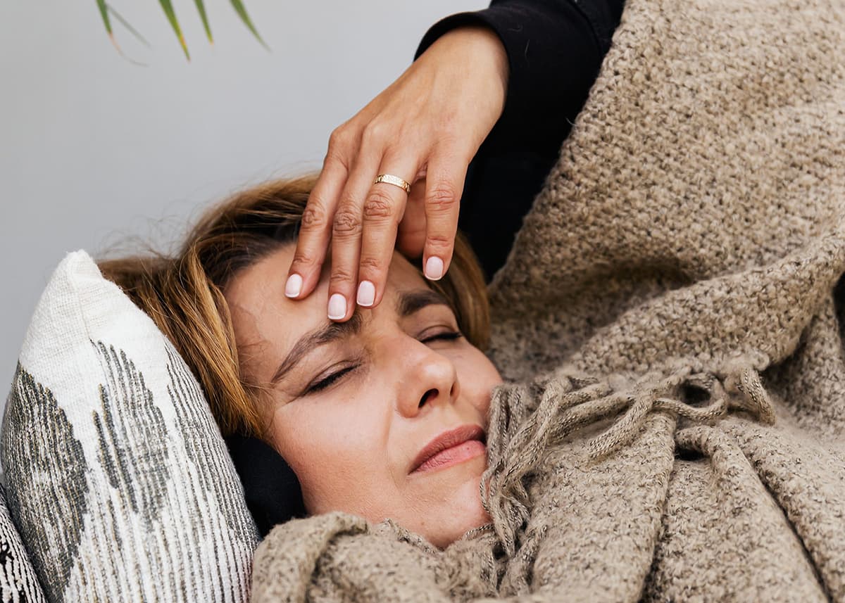 Person experiencing altitude sickness, showing symptoms like headache and dizziness